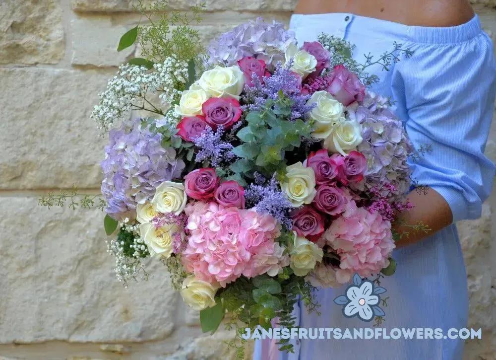 fresh pink and white roses, pink and lilac hydrangeas, fragrant eucalyptus, gypsophila, purple aster solidago, purple limonium